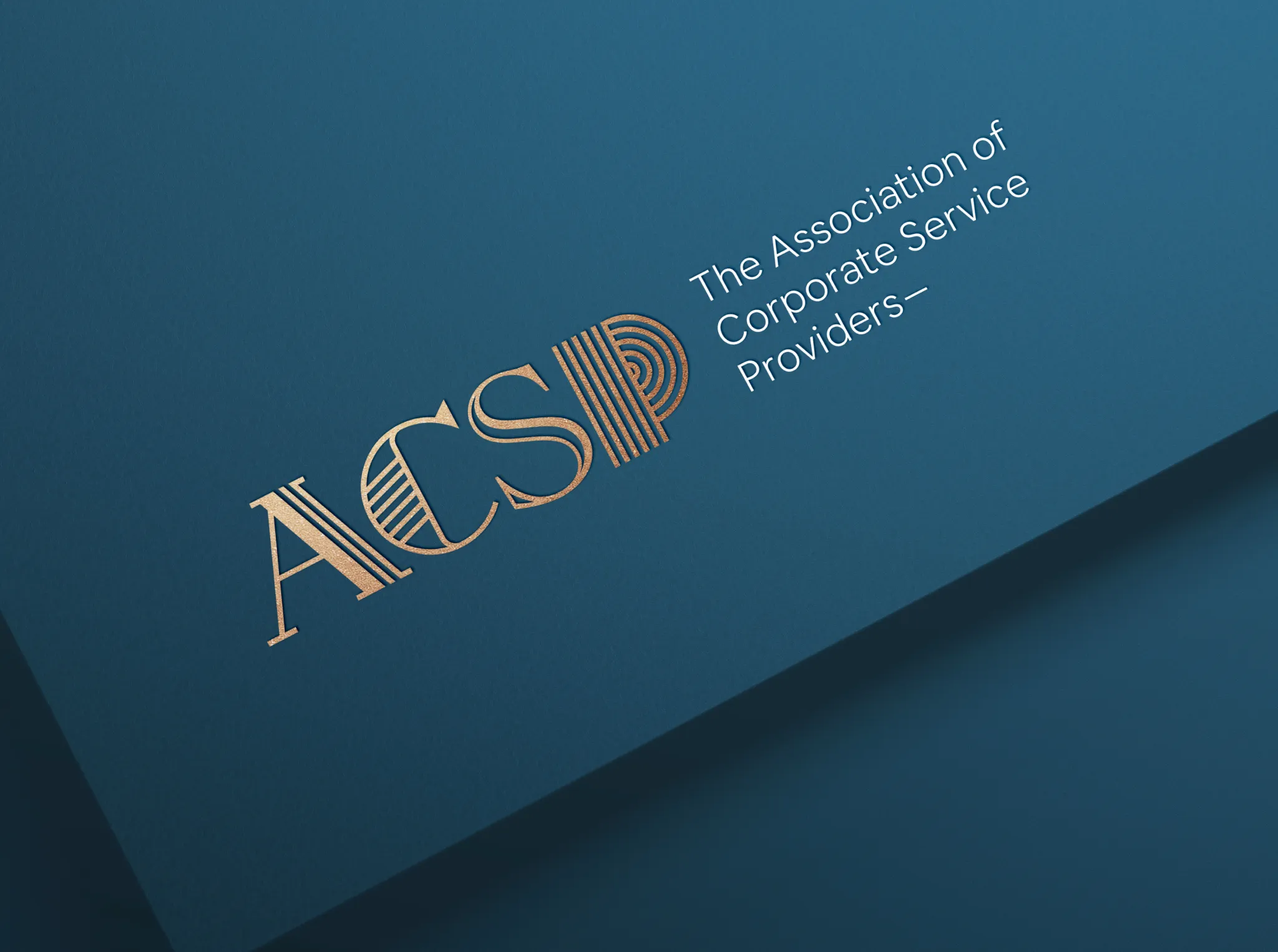 ACSP logo with gold foil finish on printed collateral, part of the brand identity developed by DotPerformance for the Association of Corporate Service Providers on the Isle of Man